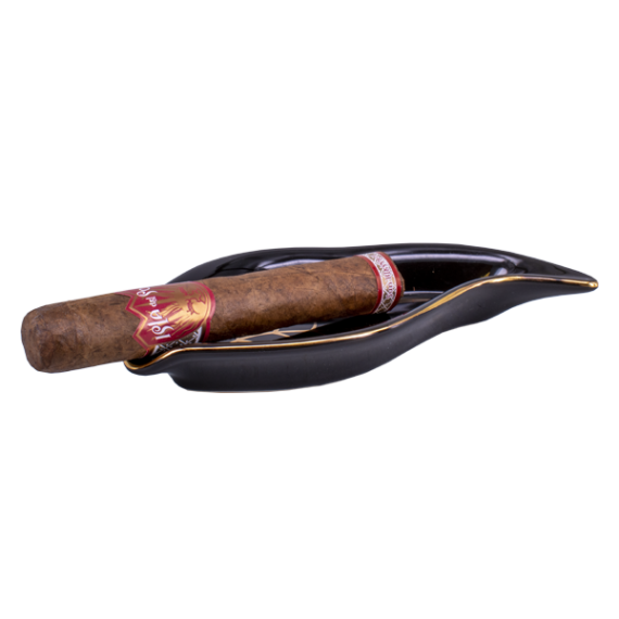 Drew Estate Isla Del Sol Robusto på ett snyggt svart lövformat askfat med guldiga detaljer